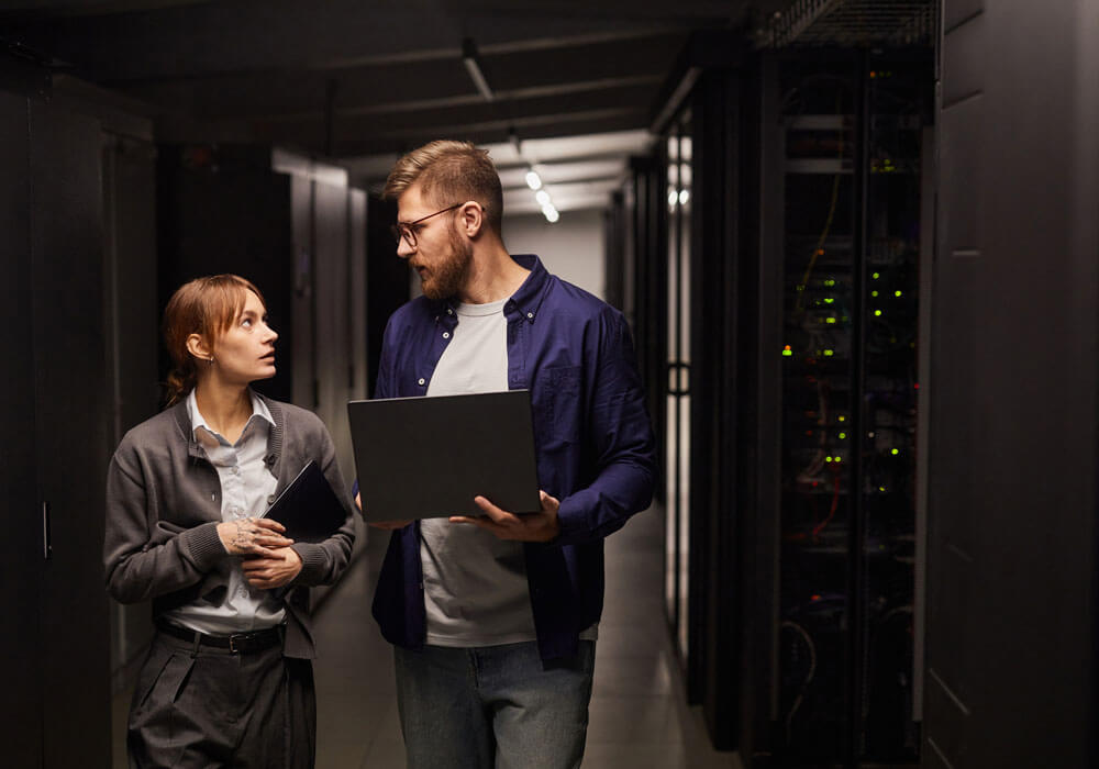 2 people in a server room