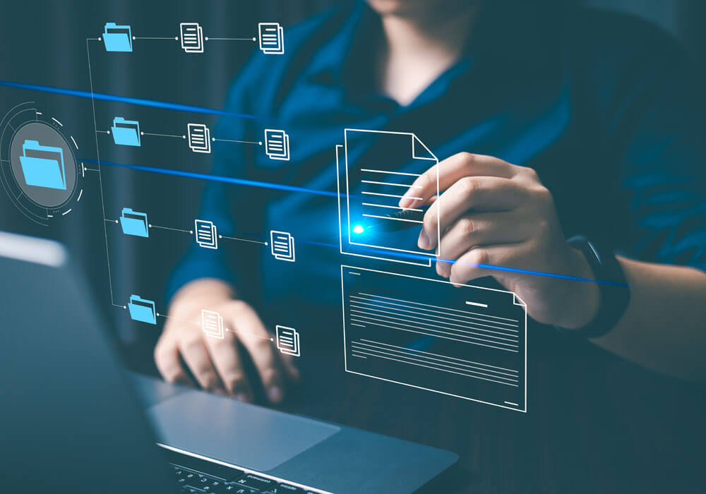 person organizing files on laptop